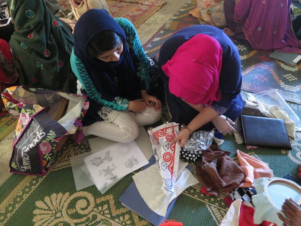 03 Students examine embroidery samples